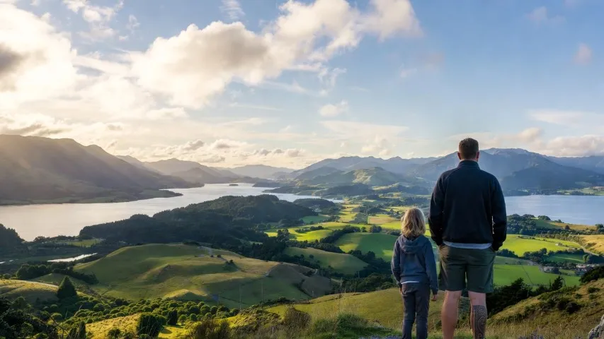 Father and child looking over New Zealand landscape
